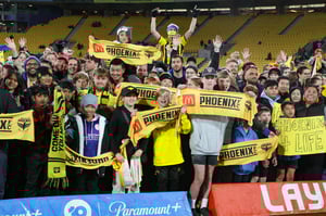 A group of young fans holding up McDonalds Wellington Phoenix A-League supporters scarves