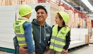 A Dad and his two young kids wearing Bunnings Trade gear made by Novelli