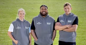 Three adults wearing Bunnings Trade Movember grey sleeveless hoodies