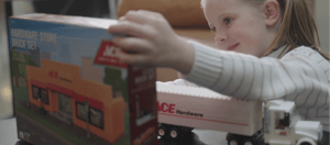 A young girl playing with Ace Hardware NovaBrix block sets