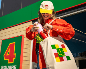 A shopper with Novelli's Four Square branded merchandise