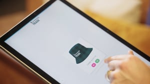 A person completing a Novelli branded merchandise survey on a tablet