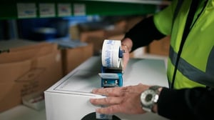 A workman in Novelli's warehouse is taping up a carton to send from the warehouse