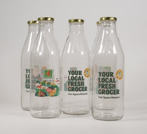 Four Square glass bottles on white background