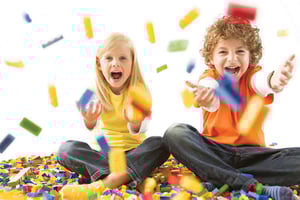Two children playing with building blocks